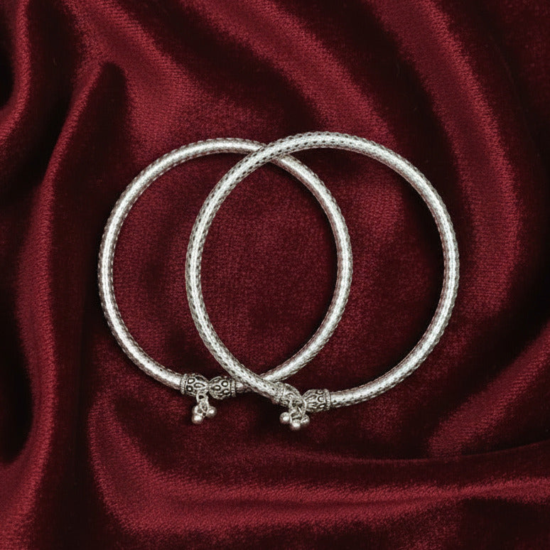 Silver bracelet on a dark fabric background