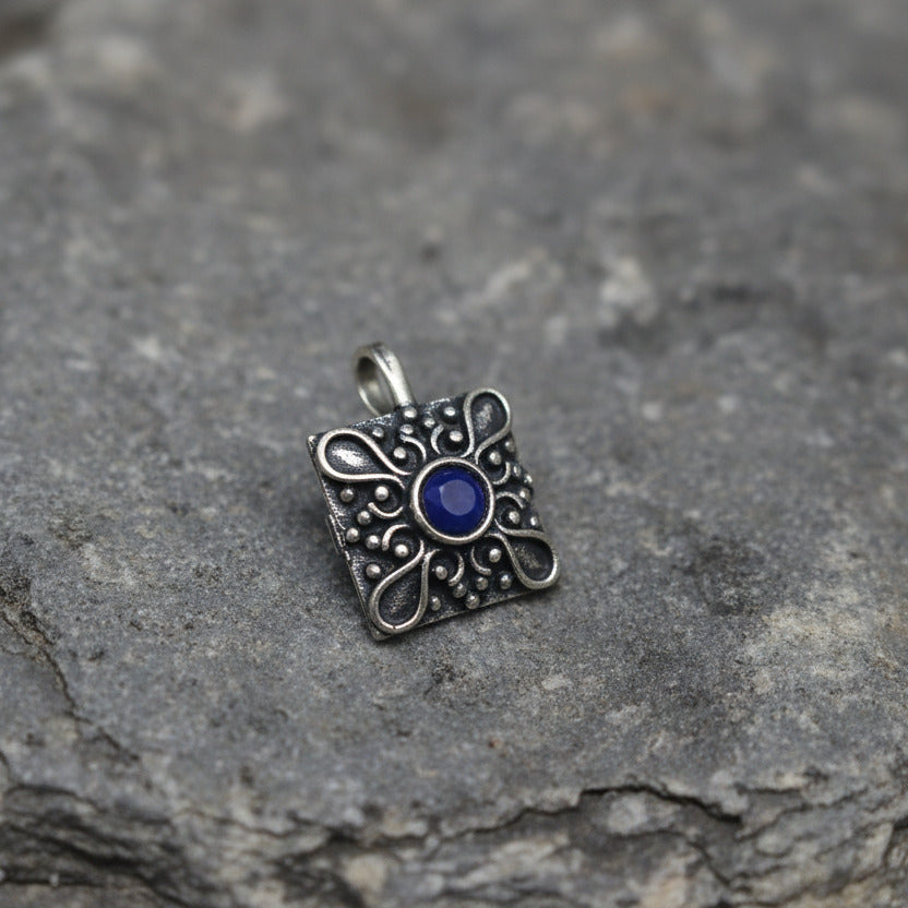 Silver ring with a blue gemstone on a white background