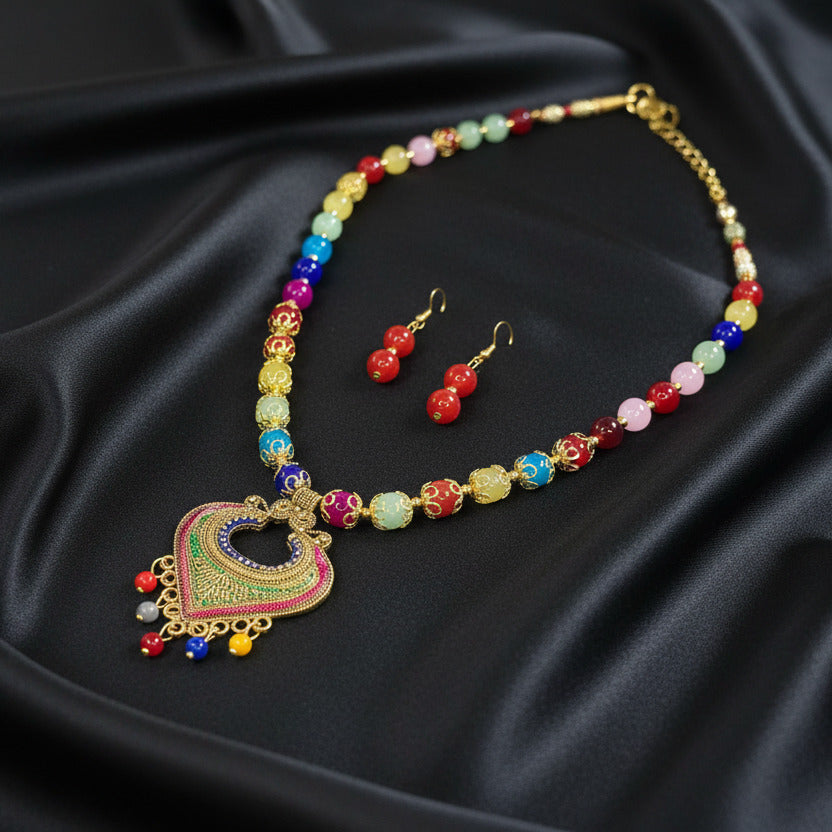 Colorful beaded necklace and earrings on a black background