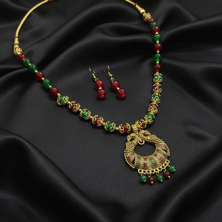 Jewelry set with necklace and earrings on a dark fabric background