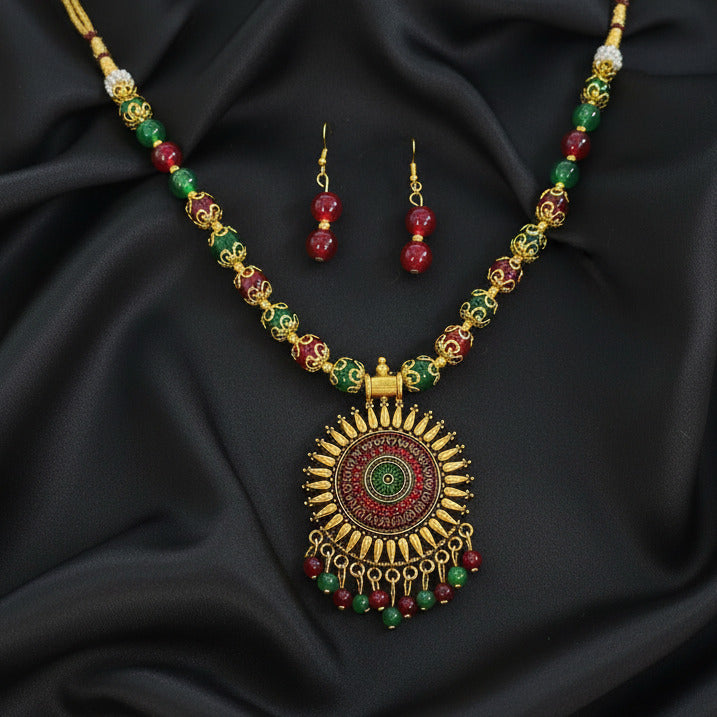 Decorative necklace with matching earrings on a dark background
