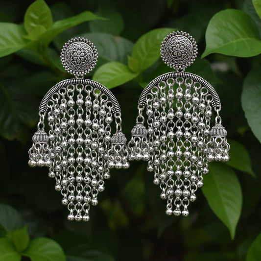 Pair of silver earrings on a light gray background