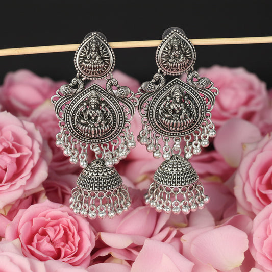 Pair of silver earrings on a black background