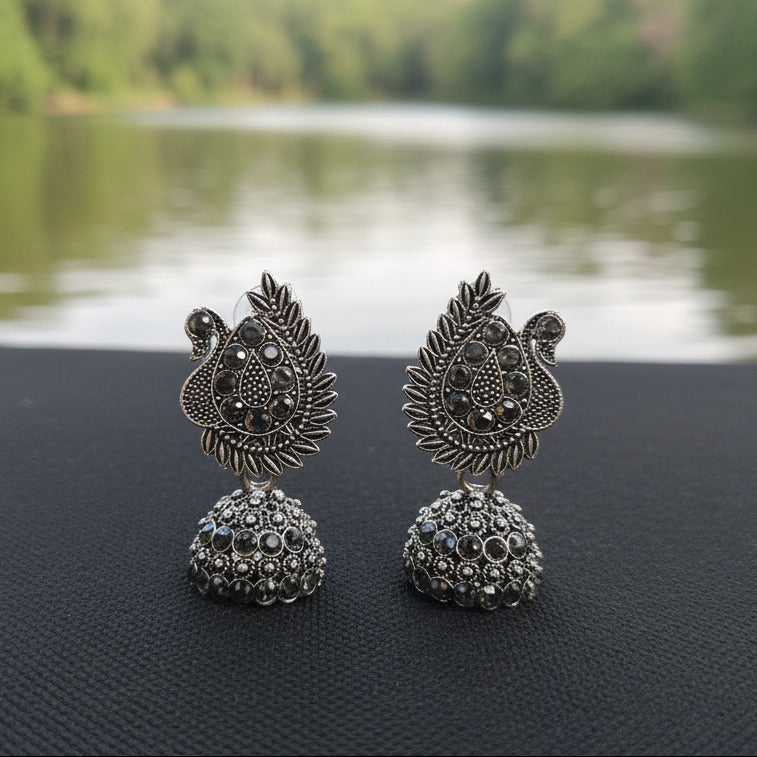 Silver beads with intricate designs on a black background