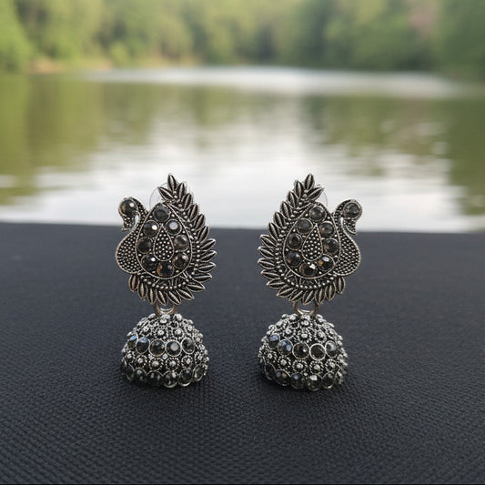 Silver beads with intricate designs on a black background
