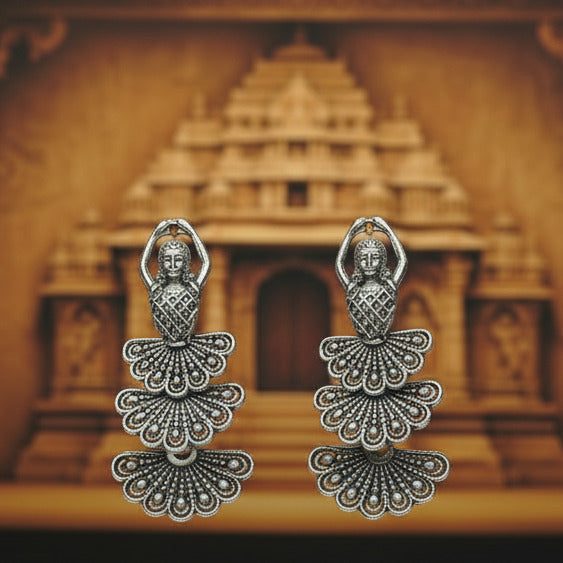 Two silver decorative hair clips on a white background