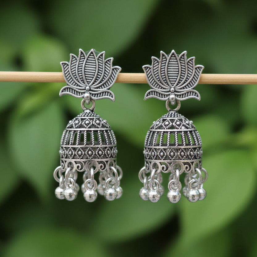 Pair of silver earrings on a black background