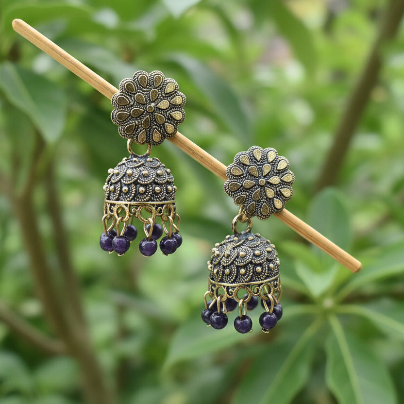 Decorative hair stick with floral designs on a dark background