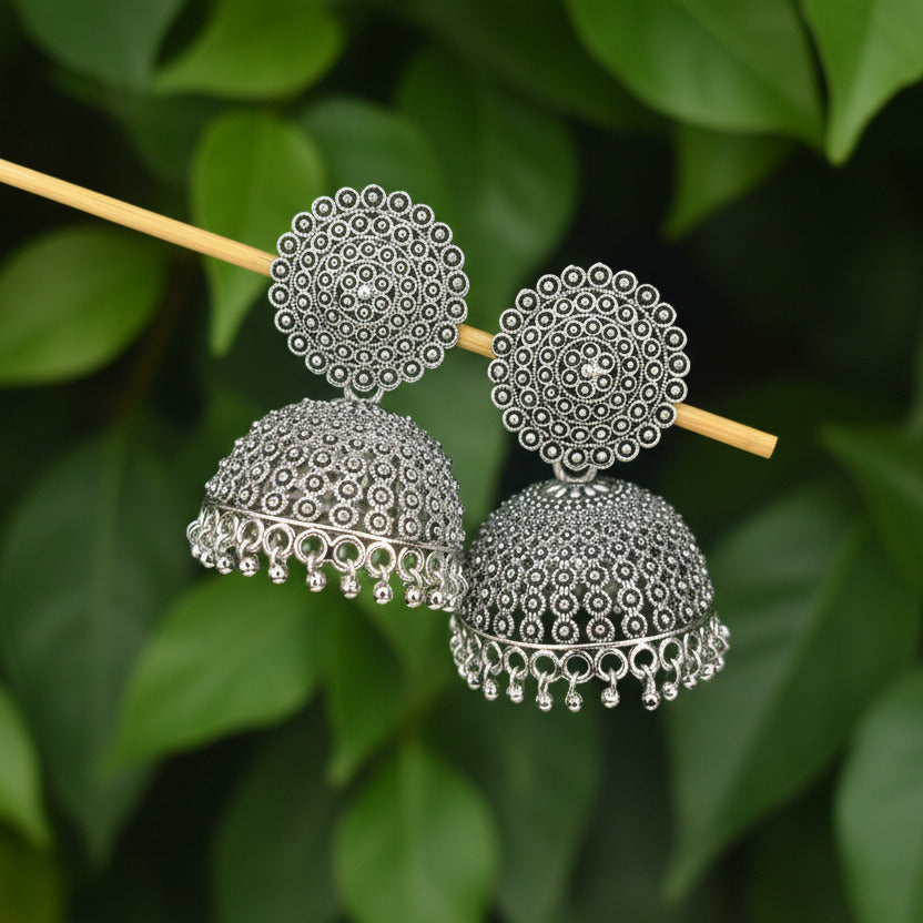 Silver beaded hair accessories on a dark background