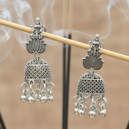 Pair of silver earrings on a black background