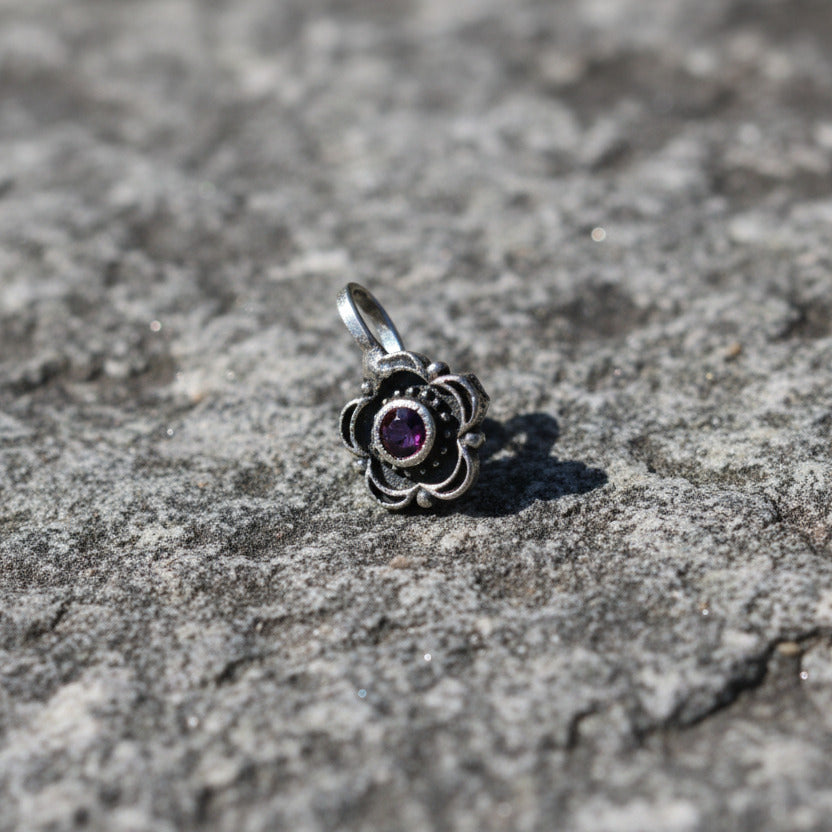 Silver ring with a floral design on a white background