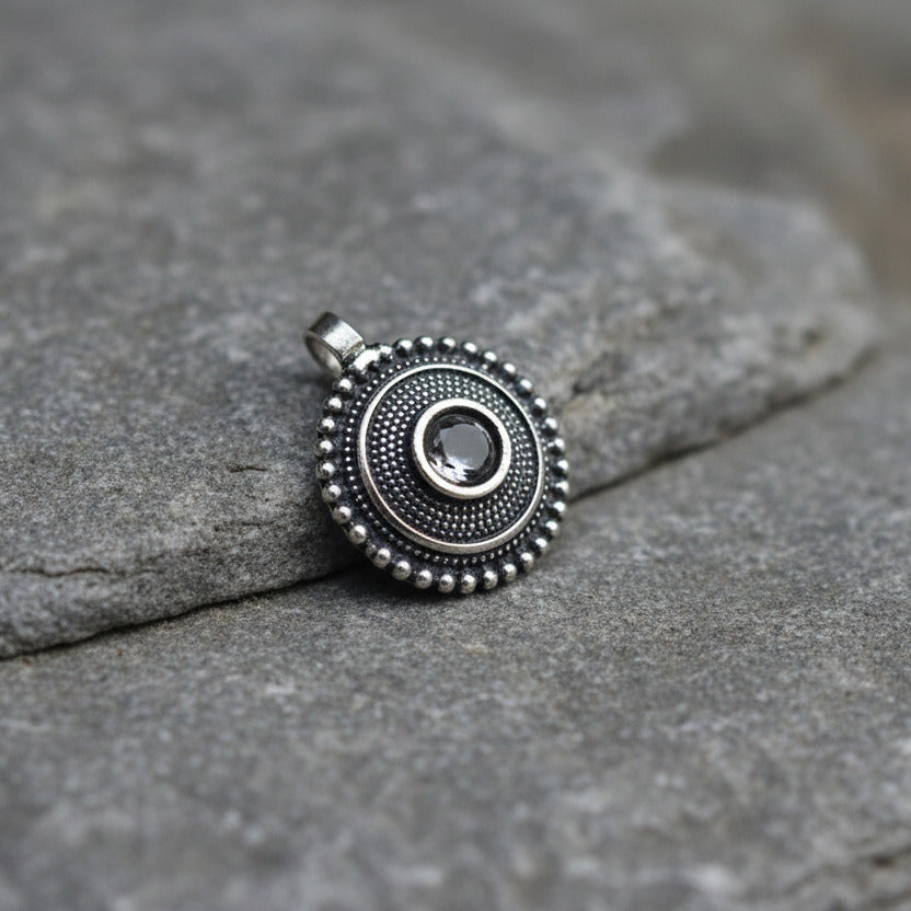 Silver ring with decorative elements on a white background