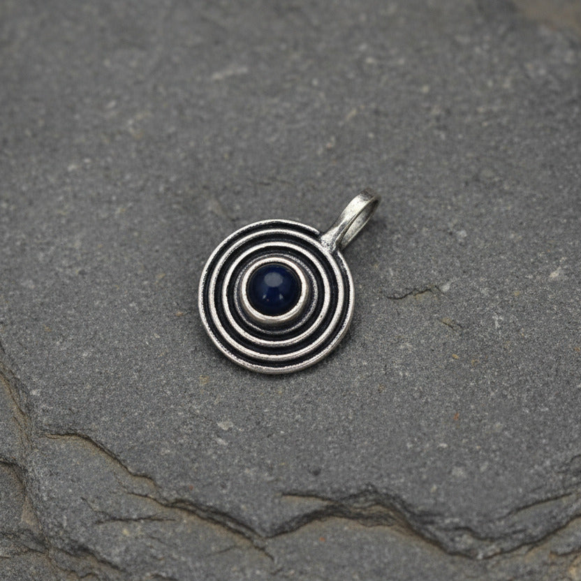 Silver spiral pendant on a light gray background