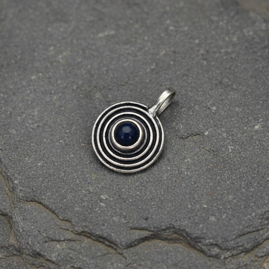 Silver spiral pendant on a light gray background