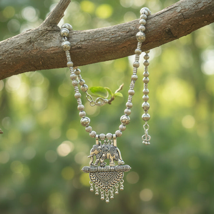 Decorative headpiece with beads and intricate design on a dark fabric background