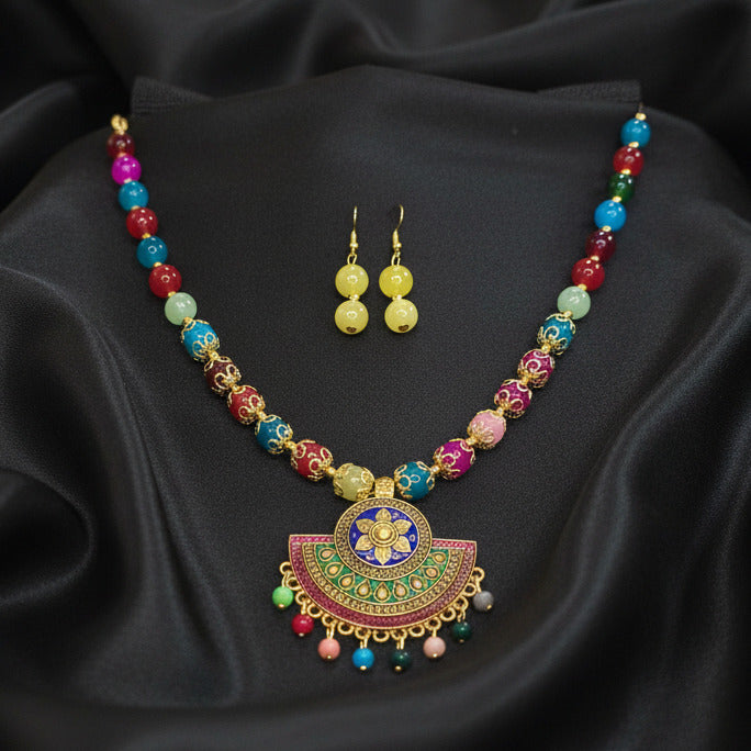 Colorful necklace with matching earrings on a dark background