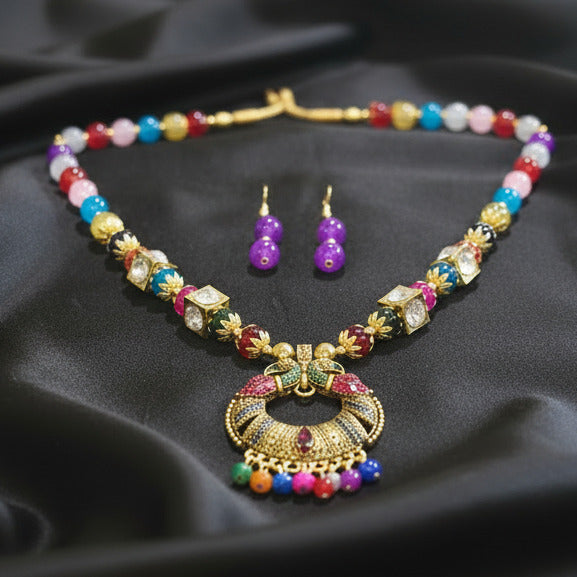 Colorful beaded necklace and earrings on a dark surface