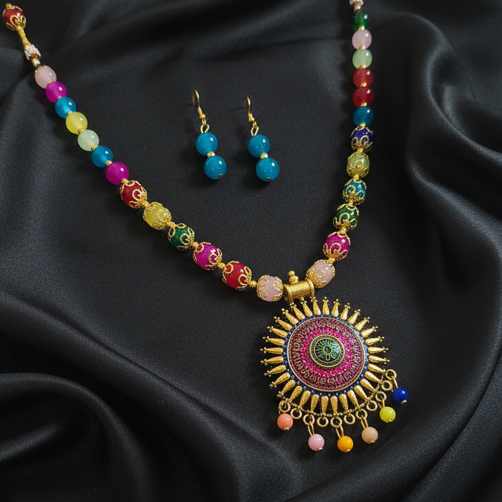 Colorful necklace and earrings set on a black background
