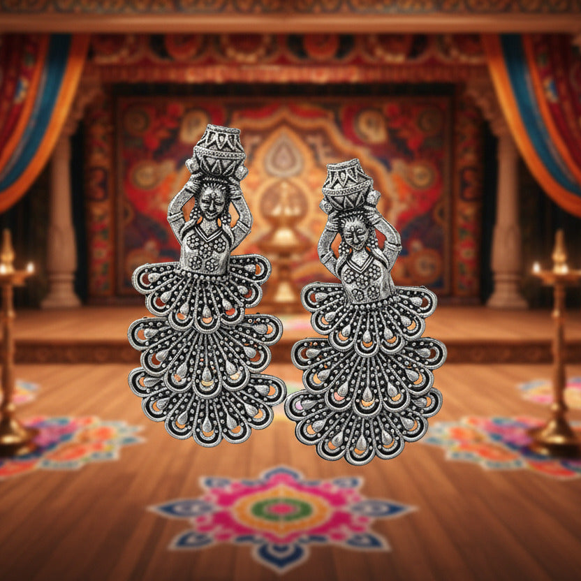 Decorative blue container with intricate silver designs on a white surface