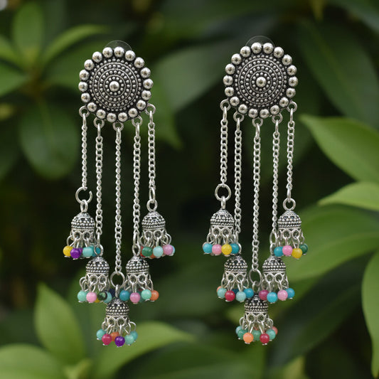 Pair of silver earrings with colorful beads on a white background