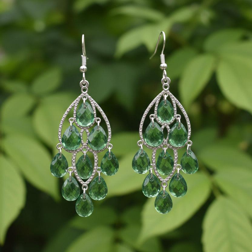 Pair of green gemstone earrings on a light gray background